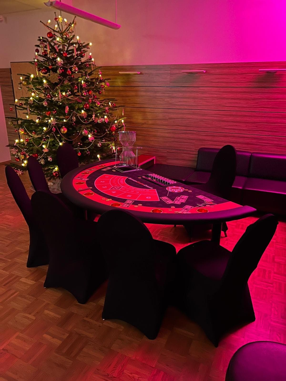 Chuck-a-Luck-Tisch neben einem Weihnachtsbaum im roten Licht